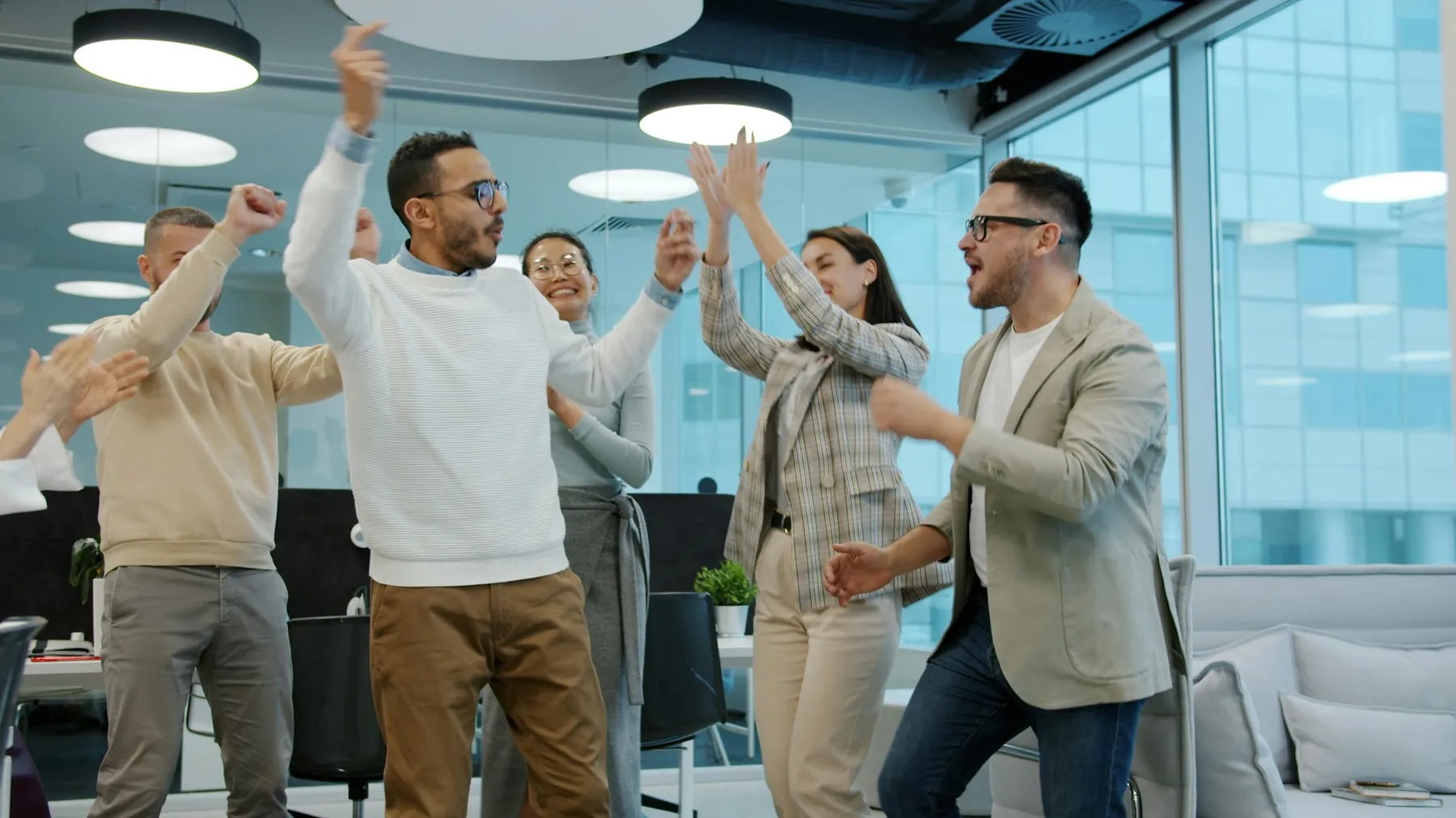Diverse team celebrating a milestone together in the office