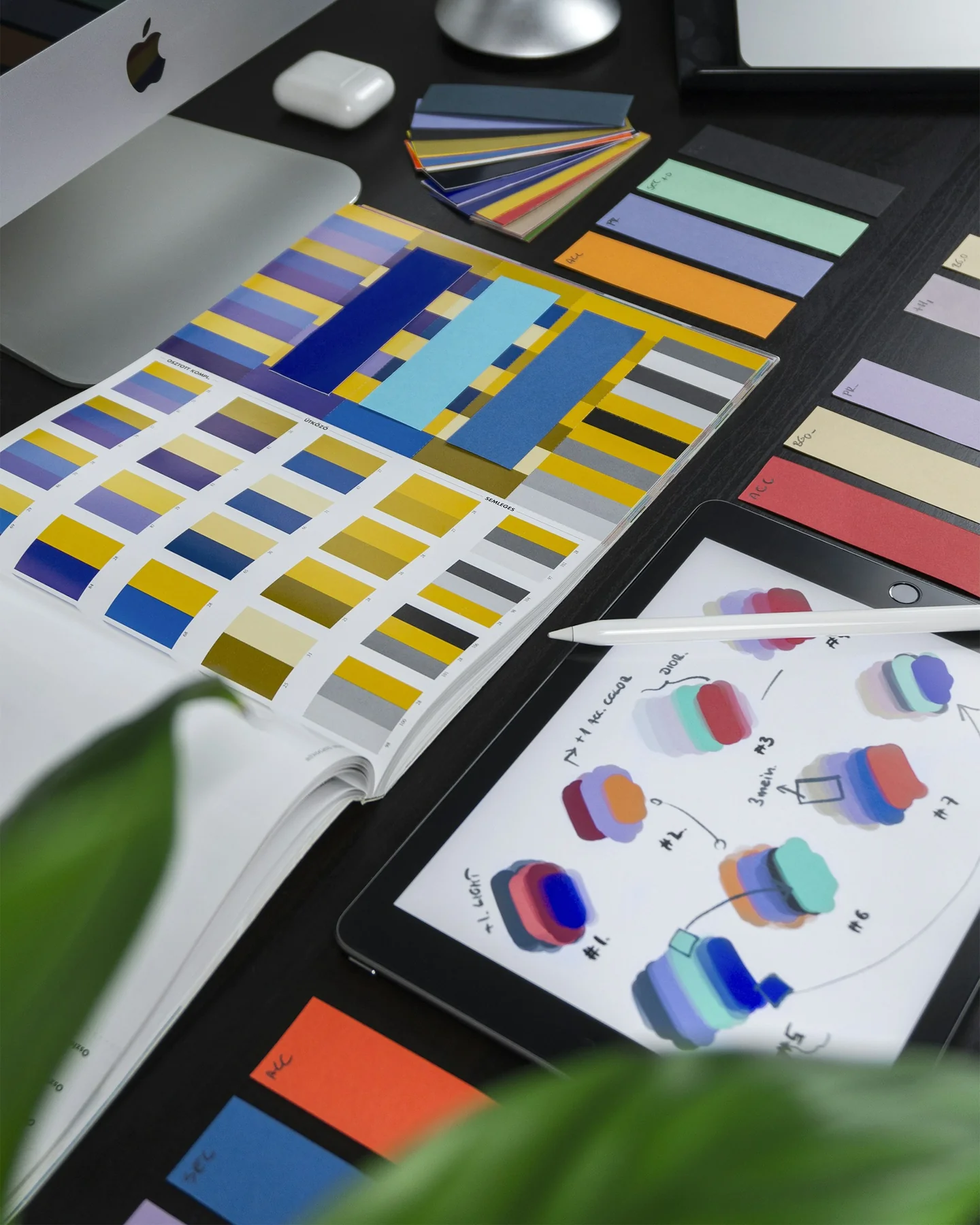 Colour swatches and design sketches on a designer's desk