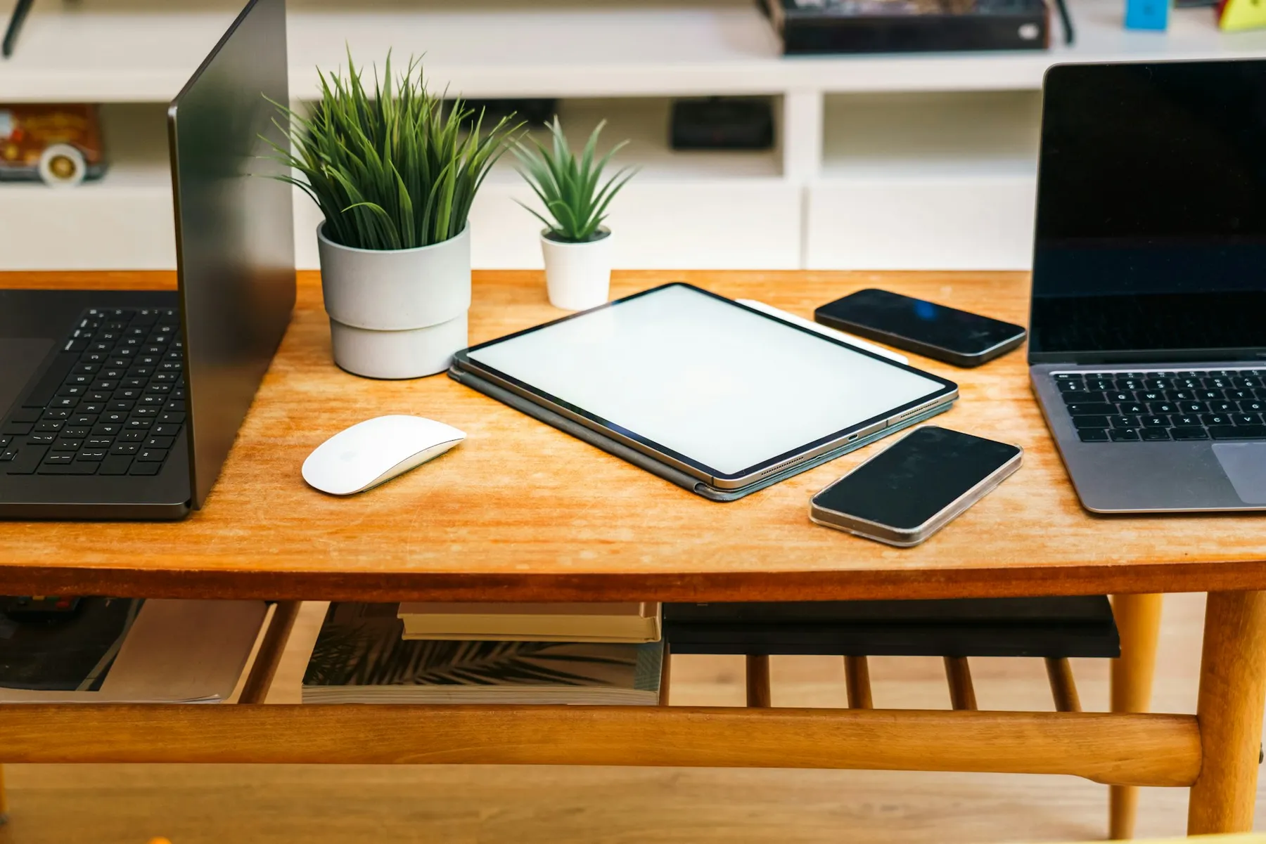 Laptop, tablet, and smartphone arranged together on a desk representing multi-discipline digital work