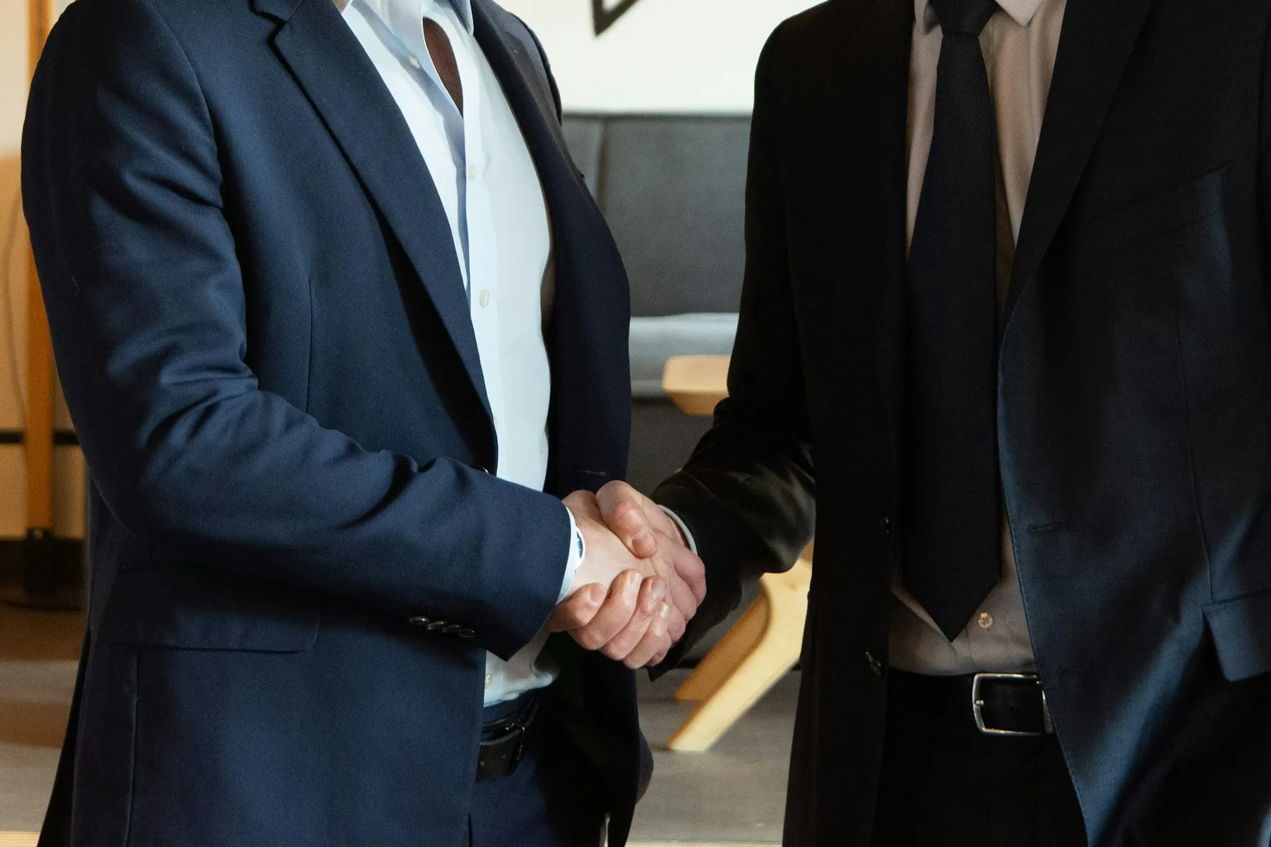 Two business partners shaking hands warmly in agreement