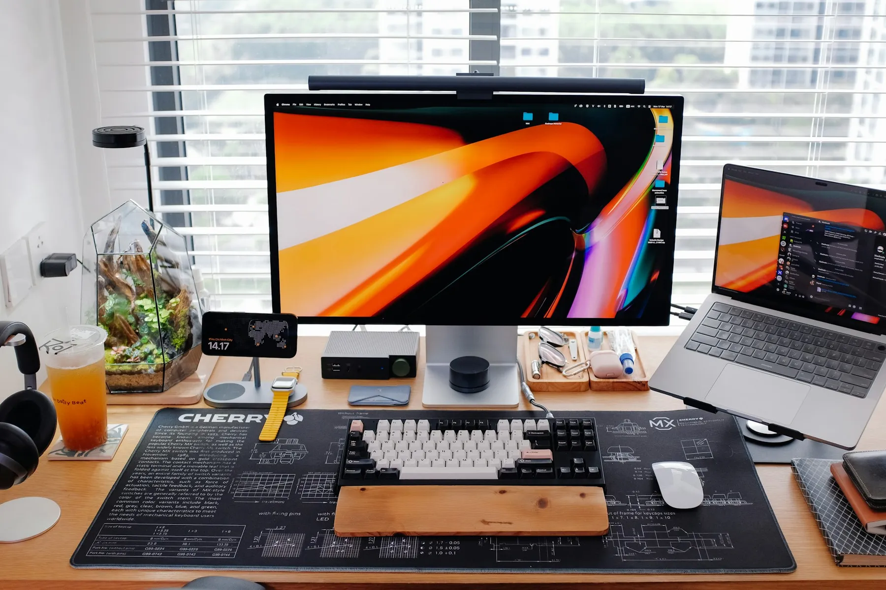 Modern desk setup with multiple monitors showing design and code